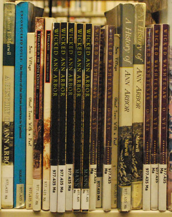 A small slice of a large shelf of books about the history of Ann Arbor at the downtown location of the Ann Arbor District Library. The AADL will be archiving the more than 10 million words that were published over the course of six years of The Ann Arbor Chronicle. 