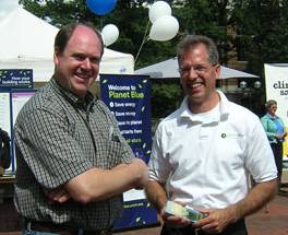 Ann Arbor City Councilman Steven Kunselman, right, works his day job as one of the organizers of this year's UM EnergyFest. He was talking with Rick Richter, who coincidentally is the second person in Ann Arbor awarded a permit to keep backyard chickens. 