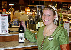Manager Audree Riesterer, dressed for Halloween, offers tasting pours of Lone Oak Merlot at Whole Food Market's wine bar.