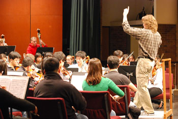 Chris Mark conducts a rehearsal Monday afternoon of the Huron High symphony orchestra.