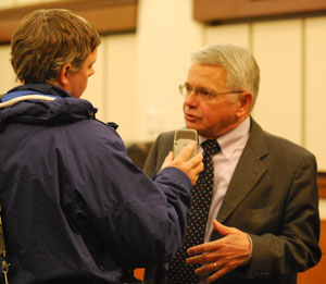 County administrator Bob Guenzel is interviewed by WEMU reporter Andrew Cluley during a break at Wednesday night's board of commissioners meeting.
