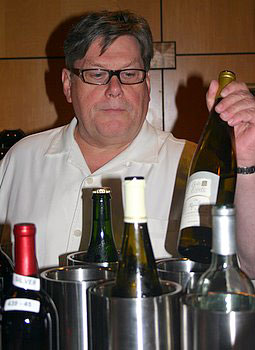 Chris Cook lifting a bottle of wine out of a bucket.