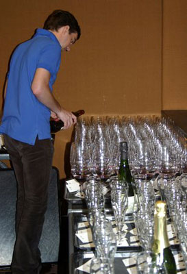a man pouring glasses of wine