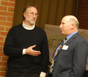 At left: Architect John Mouat, a member of the Fuller Road Station design team, talks with Eli Cooper, the city's transportation manager, before the start of the Feb. 10 citizen participation forum. Moaut is a partner in the Ann Arbor firm of Mitchell and Mouat. (Photos by the writer.)
