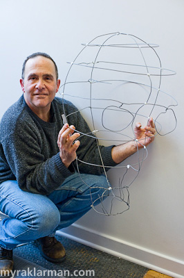 Rick Cronn holds his wireframe of a giant head.