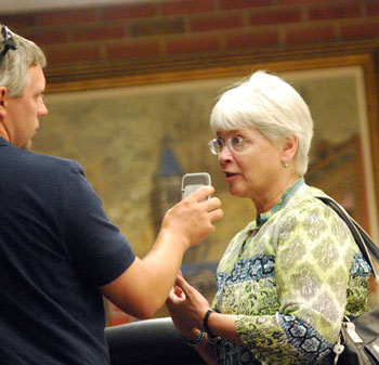 Andrew Cluley, of WEMU, interviews Marcia Higgins after the meeting.