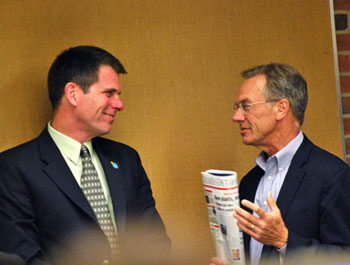 City administrator Steve Powers (left) chats with University of Michigan community relations director Jim Kosteva before the meeting. Kosteva was not attending the meeting in connection with the rail project, but to receive an award on behalf of the university from the city's historic district commission for the university's Burton Tower.