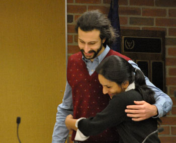 Before the meeting, Sumi Kailasapathy gets a hug of support from Washtenaw County commissioner Yousef Rabhi.