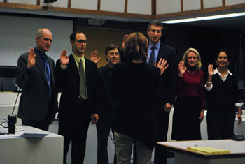 The newly elected members of council are sworn in by city clerk Jackie Beaudry (back to camera). From left: mayor John Hieftje, Chuck Warpehoski (Ward 5), Margie Teall (Ward 4), Christopher Taylor (Ward 3), Sally Petersen (Ward 2) and Sumi Kailasapathy (Ward 1). 