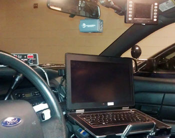 Interior of Ann Arbor police patrol car showing the computer hardware they've been equipped with for many years.