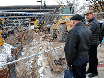 Before the Feb. 21, 2013 meeting of the AATA board, Terry Black (manager of maintenance) and Eli Cooper (AATA board member) inspect the construction site of the new Blake Transit Center on Fifth Avenue in downtown Ann Arbor.
