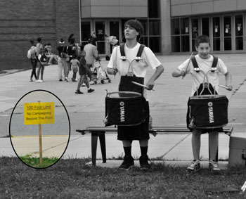 Members of one of the Pioneer High School marching band drum lines practiced on the evening before Election Day near the yellow sign indicating that no campaigning is allowed beyond that point. Pioneer High serves at the polling location for Precincts 4 & 8 in Ward 4.