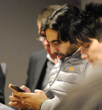 Rishi Narayan checked his smartphone before the meeting started.