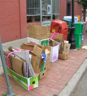 Chelsea Flowers' cardboard bundles are tied off with a bright pink ribbon.