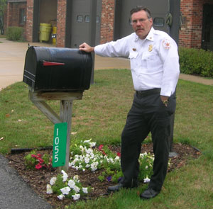Scio Township Fire Chief, Carl Ferch in front of the fire stations own reflective mailbox sign.  