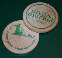 People that receive federal food aid will soon be able to make purchases at the Ann Arbor Farmers Market, using these wooden tokens.