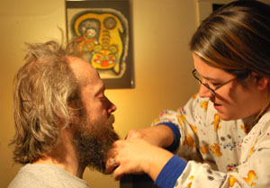 Chantelle checks a beard for signs of lice. 