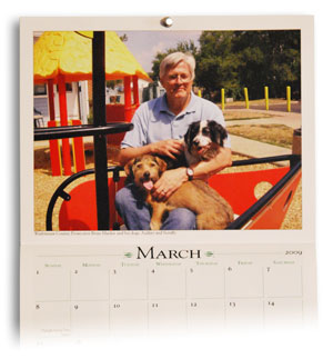 Brian Mackie, Washtenaw County prosecutor, with his dogs in the Political Pets of Washtenaw County 2009 calendar.
