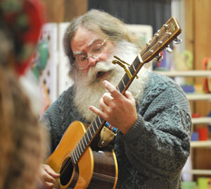 David Menefee serenades shoppers at Sunday's Art in the Barn.