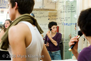 A cast member of Miss Saigon puts on makeup before Friday night dress rehearsal.