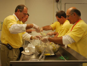 Volunteers from Frito-Lay pack pickles.