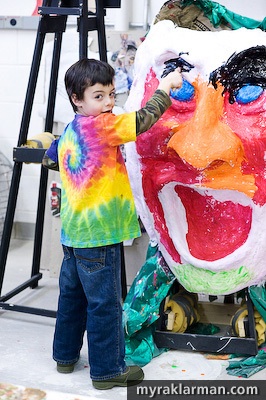 Max Klarman paints a papier-mache mask at Saturdays FestiFools open house.