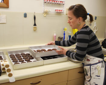 Maite Zubia stacks a tray of chocolate-dipped alfajores to cool.