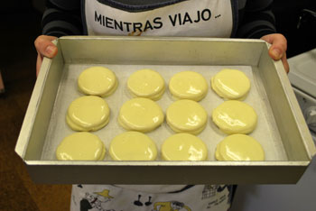 A tray of alfajores dipped in white chocolate.
