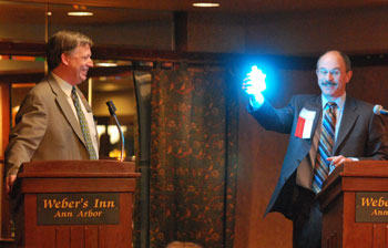 Ed Pagani holds aloft a chemiluminescent compound that Russ Collins was not tempted to drink.