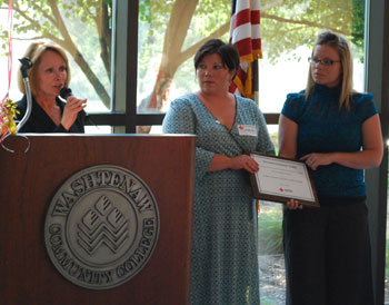 Donna Duvin, left, gives an award to Cassie and 