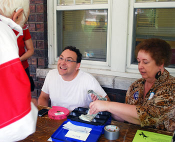 Conan Smith, chairman of the Ann Arbor Democratic Party and a Washtenaw County commissioner, sells tickets to the Labor Day picnic with Kathy Wyatt.