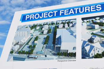 This rendering of the proposed Fifth Avenue parking project, on a billboard next to the downtown library, shows the proposed Library Lane running between Fifth and Division. The large building on the right of the image is a new library building – a project that was called off late last year. (Photo by the writer.)