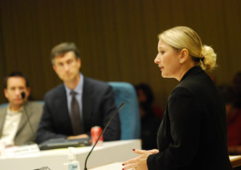 woman standing at microphone addressing a public body