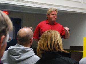 Colin Smith, the city's parks and recreation manager, gives an update on initial recommendations for raising revenue and cutting expenses at Mack Pool. The Dec. 10 meeting was held in the auditorium of Ann Arbor Open.
