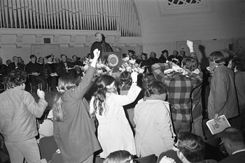 Demonstrators disrupt a ceremony at Hill Auditorium during the Black Action Movement strike of March 1970. President Robben Fleming stands at the podium.