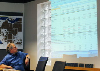 DDA board member Roger Hewitt gazes at a wall of numbers.