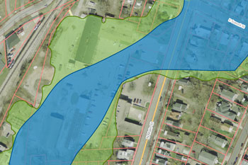 721 N. Main Parcel. Blue area is FEMA floodway. Green area is FEMA floodplain. The FEMA grant for demolition of buildings does not include the main building, which is in the floodplain (green area).