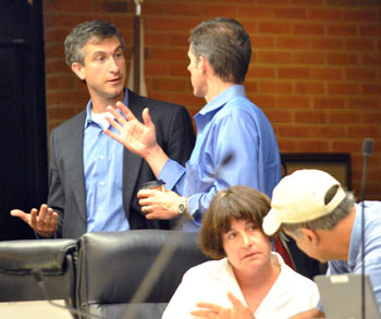 Left to right: Christopher Taylor (Ward 3) chats with Carsten Hohnke (Ward 5) during a recess in the meeting.