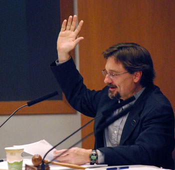 Ann Arbor Transportation Authority board chair Charles Griffith raises his hand to vote yes on the resolution of appreciation for David Nacht.