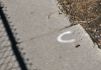 A sidewalk marked with a "C" – which indicates it needs to be cut flush – on Fifth Avenue south of William Street. 