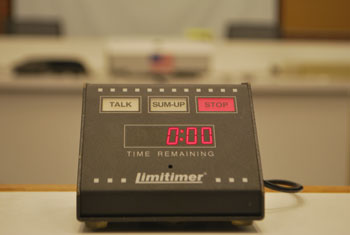 This is the electronic time clock at the public speaking podium in Ann Arbor's city council chambers. The elements in red (except for the American flag in the background) have been digitally added. 